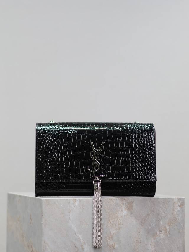 The timeless classic black, silver-buckled, crocodile-patterned Kate 24cm tassel