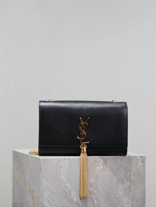 The timeless classic black gold-buckled Caviar Kate 24cm tassel bag is a timeles