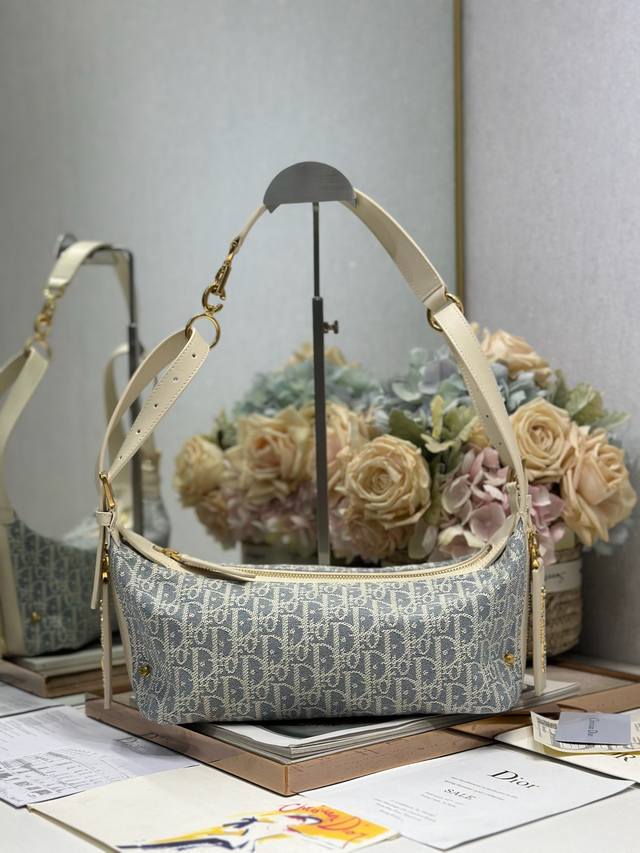 Authentic, high-edition small D-Journey handbag in gray with leather. This D-Jou