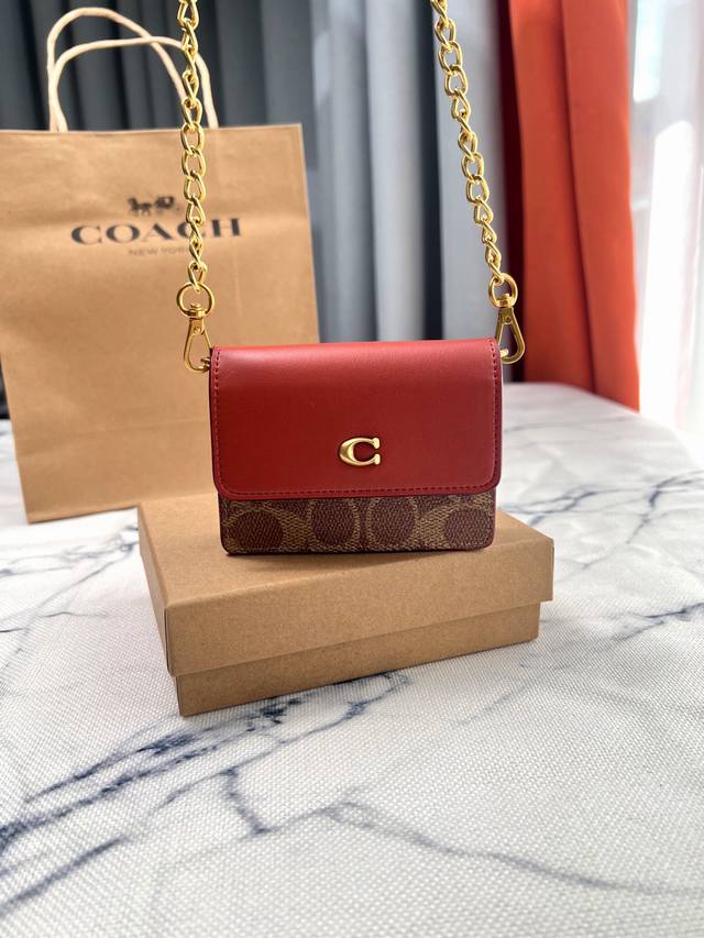 Coach's stylish classic mini square bag with print and brown chain is small, cut