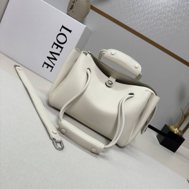 Luo Jia's new small soft grained cowhide leather Madrid handbag features a soft,