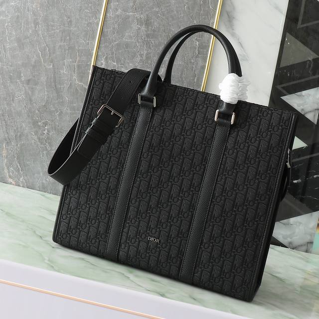 The East-West bag embodies timeless elegance. Crafted from black Oblique print f