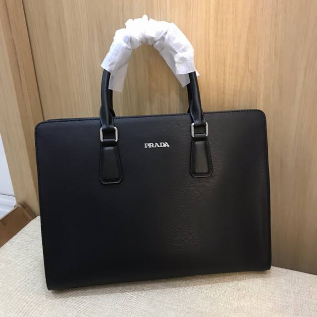 Prada is shipping! This briefcase features genuine YKK hardware