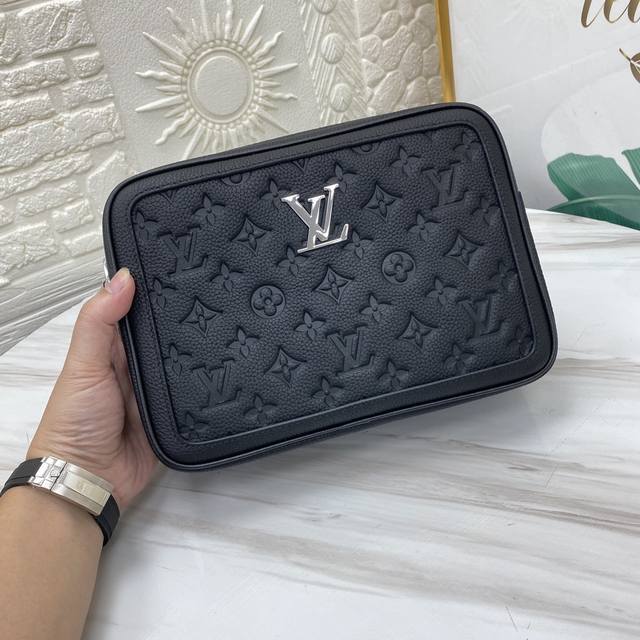 Louis Vuitton's printed embossed messenger bag, a classic travel accessory, is r