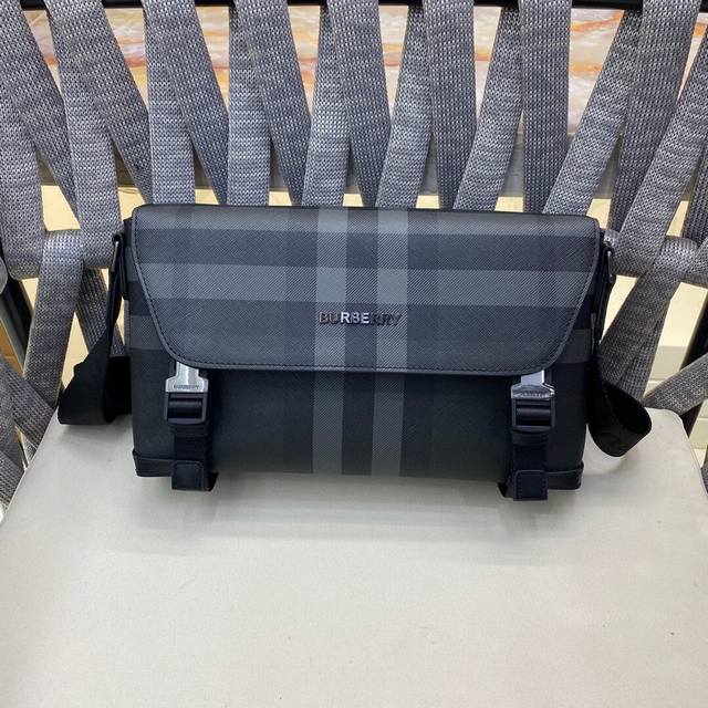 This structured messenger bag features a charcoal grey Burberry check pattern an