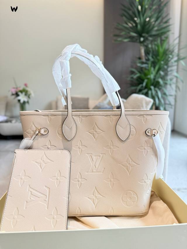 A medium size Neverfull embossed leather bag with Lv embossing. The medium size