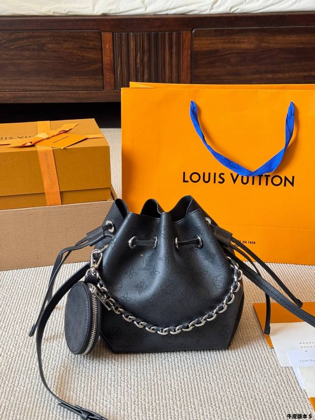 Bella bucket bag features a compact silhouette crafted from perforated calfskin