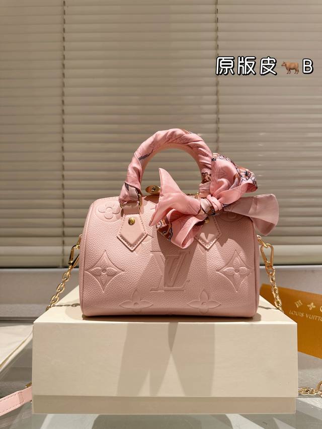 This cowhide version with a silk scarf features a LV Speedy pillow bag with a de