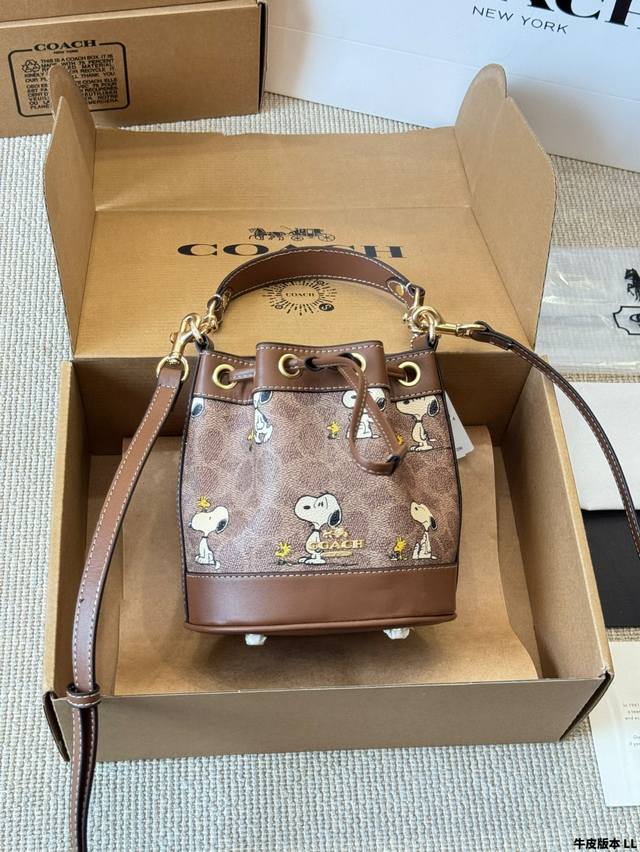 cowhide version of the Coach Dempsey Snoopy mini bucket bag. The most beautiful