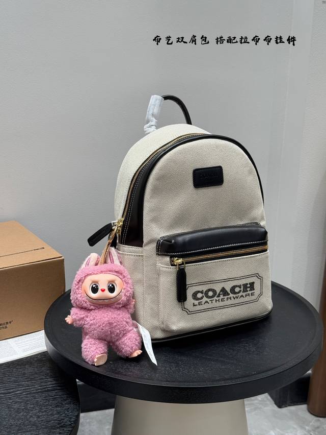 with pull-on bag pendant. Coach canvas backpack. Unisex style. Large capacity fo