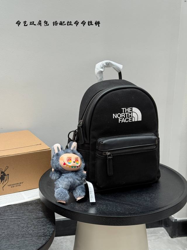 The North Face canvas backpack with pull-on accessories. Unisex style. Large cap