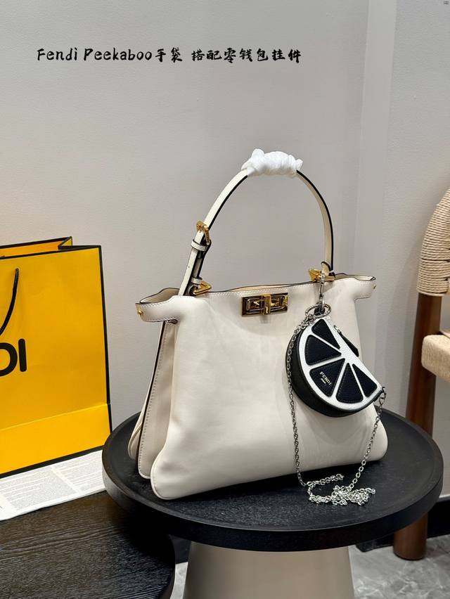 Folding gift box with small pendant. The Fendi Fendipeekaboo handbag is the epit