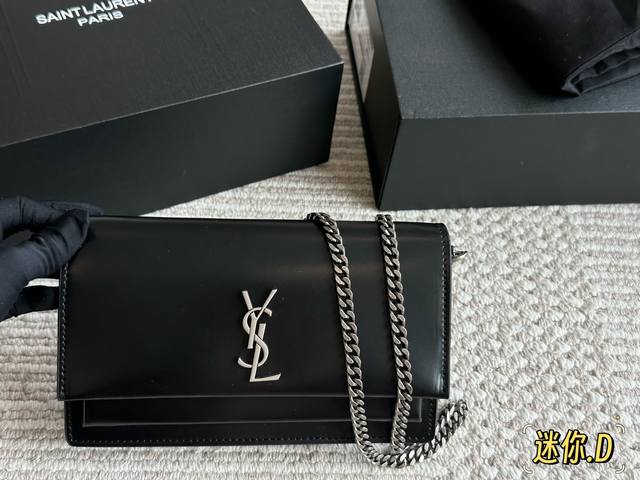Small size YSL classic sunset bag in black and gold leather. Very fashionable an