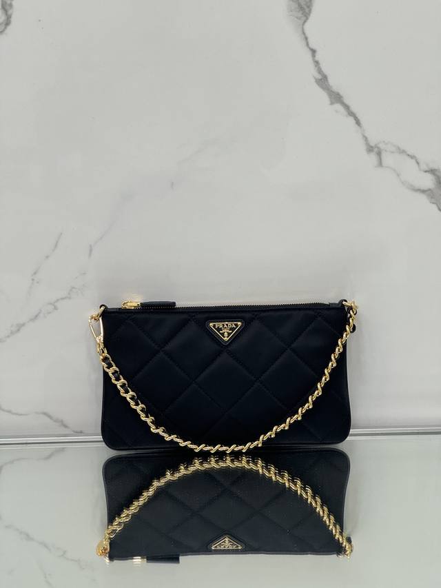Chain Underarm Bag This clutch is crafted from recycled nylon, a sustainable evo