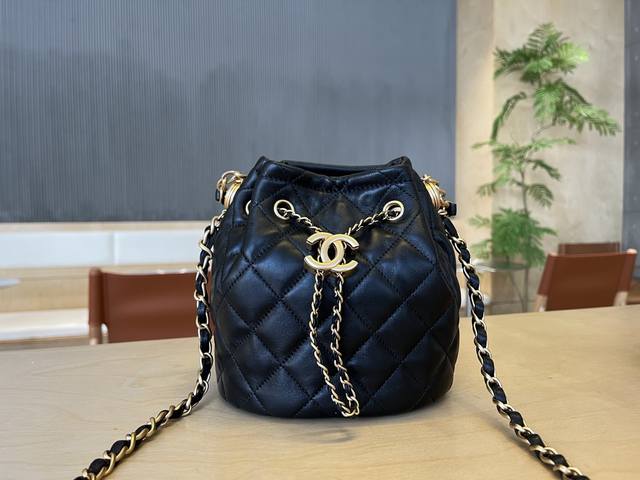 As2057 Chanel's vintage drawstring and button bucket bag features Chanel's class