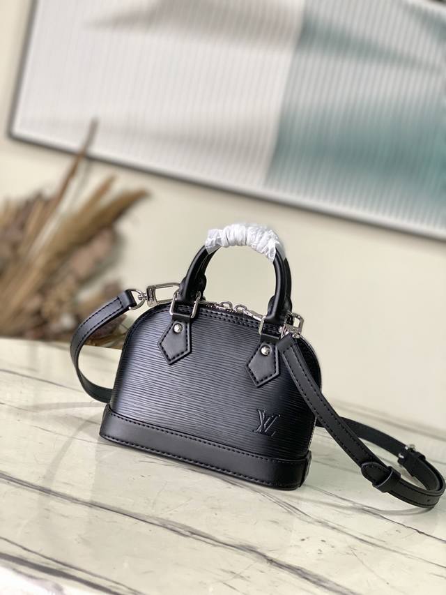 Top-grain leather, original M81945, black. This Nano Alma handbag embodies the c