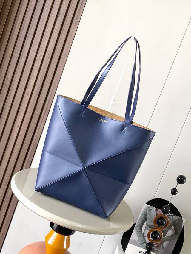 The new shiny cowhide Puzzle Fold handbag plays with geometric patterns again. I