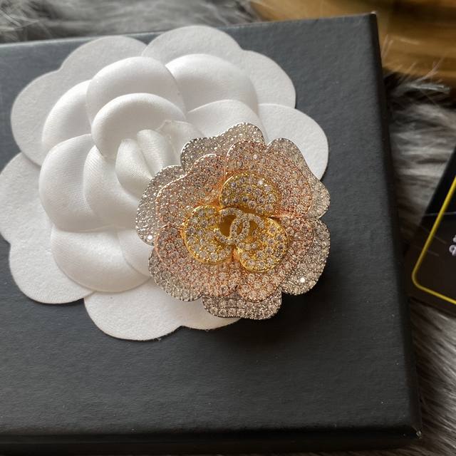 Chanel's new colorful camellia brooch is a truly feminine accessory. Women who d