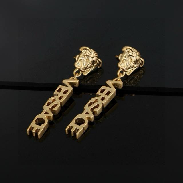 Versace These gold-tone earrings are an elegant accessory, adorned with a Medusa