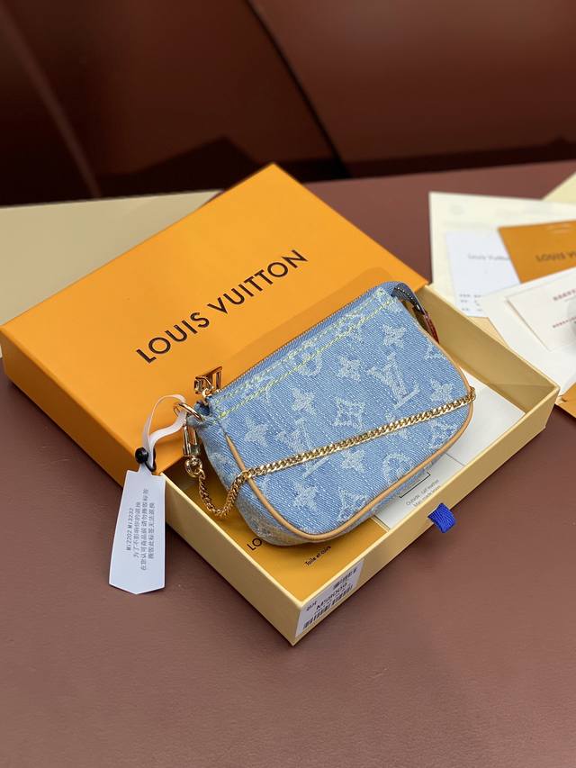 M58009 Blue! This Mini Pochette Accessoires clutch is crafted from Monogram Deni