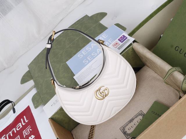 Price in Volume Description: This mini handbag, with its crescent-shaped silhou
