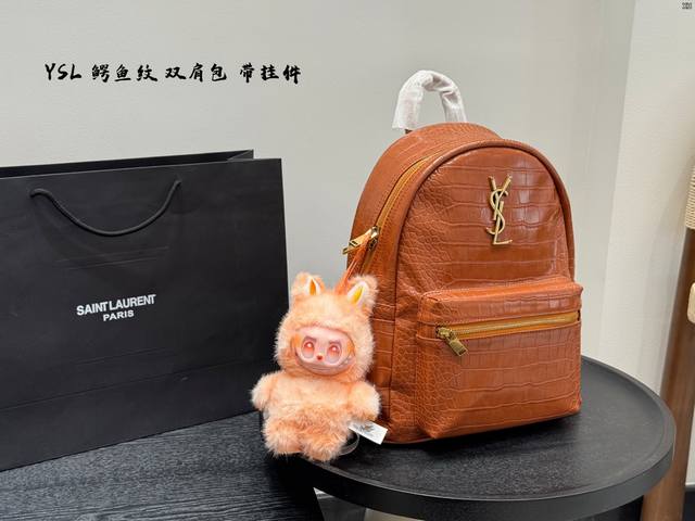 Paired with a Labu pendant Ysl Saint Laurent's new crocodile-print backpack Uni