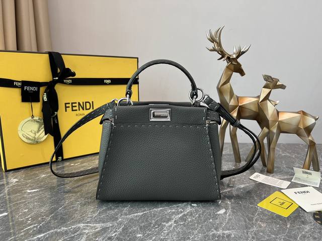 244 Small handbag with two compartments, separated by a hardboard. Twist locks o