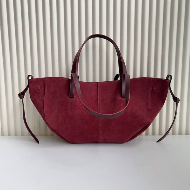 The popular polene Cyme classic tote bag has a suede texture with smooth lines
