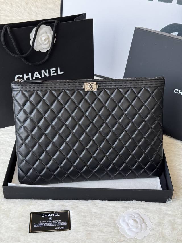 Authentic Chanel Leboy clutch. Still a trendy three-sided design, made from impo