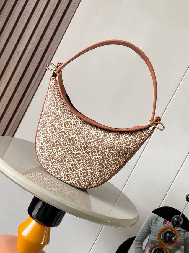 The Luna half-moon Hobo bag features a sleek design with a sculpted silhouette a