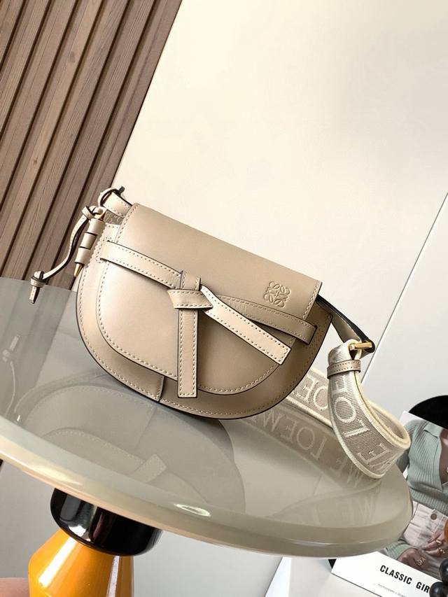 The popular mini 21cm saddle bag with wide lettered shoulder straps. The wide sh
