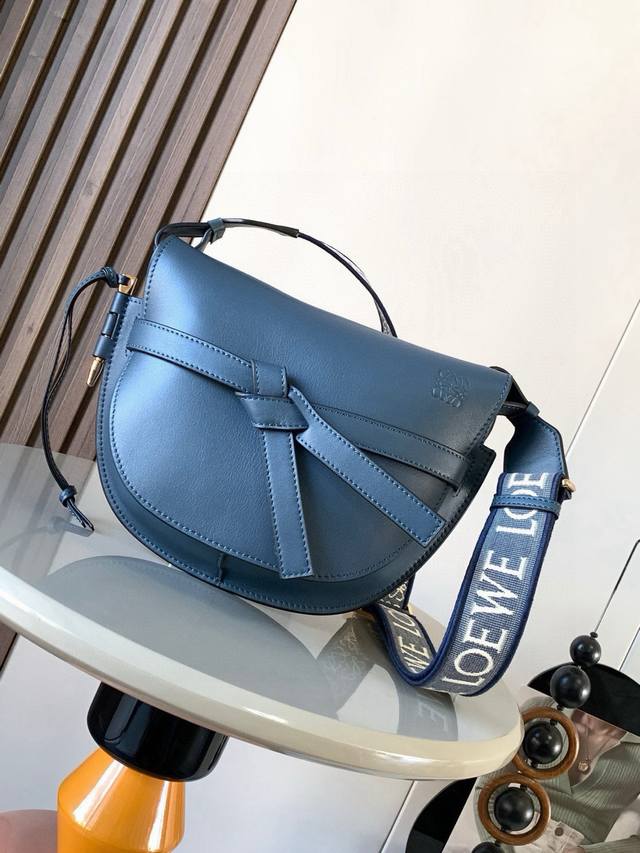 A popular small 25cm saddle bag with a new wide lettered shoulder strap. The wid