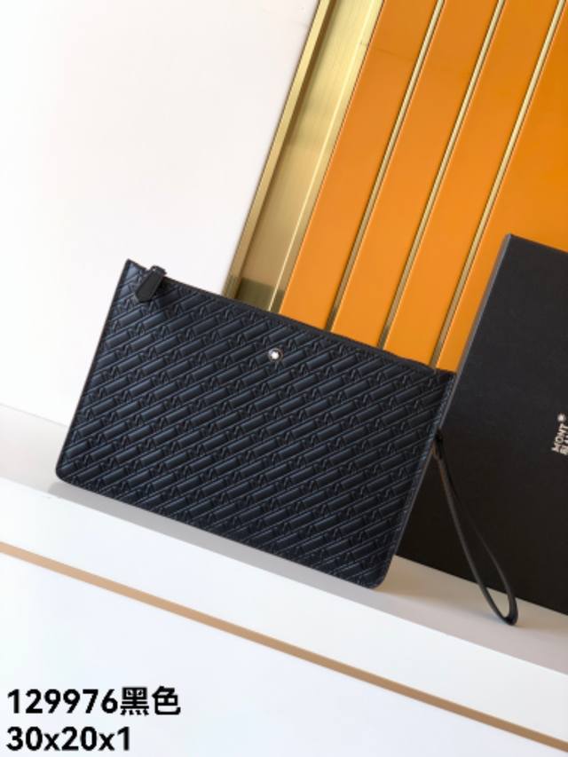 Clutch: 129976# Black, exclusive top-grain cowhide with embossed pattern. The M