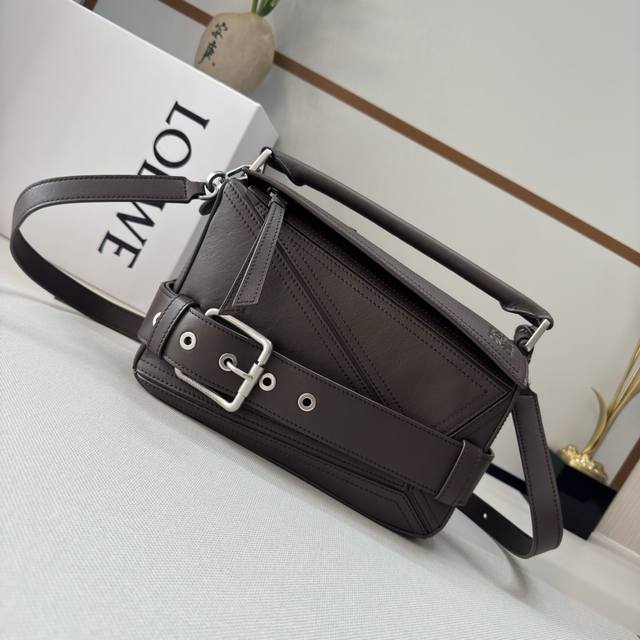 Luojia's new small shiny cowhide puzzle biker bag. The puzzle handbag features a