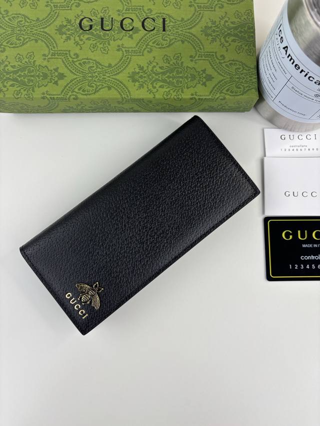 Guccl's latest Animalier long wallet features an imported bronze bee logo, pig-g