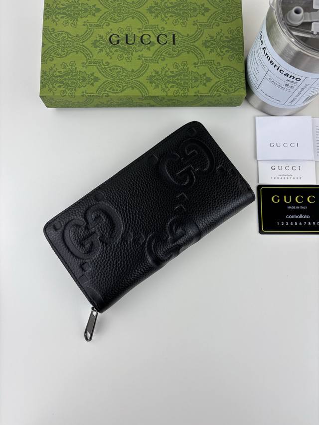 Guccl Super Double G zip-around wallet. The embossed GG print transforms a small