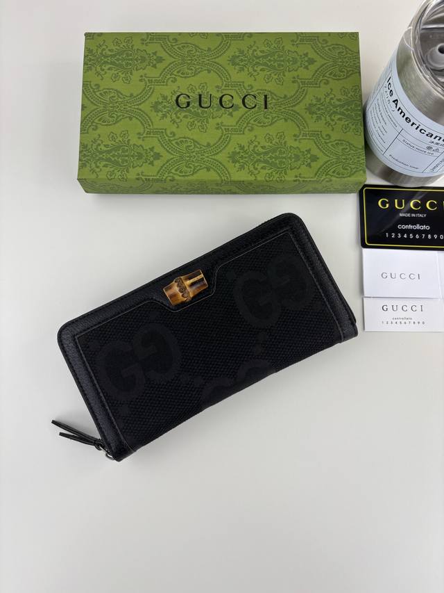 Guccl Bamboo Wallet. This zip-around wallet embodies the brand's recognizable e