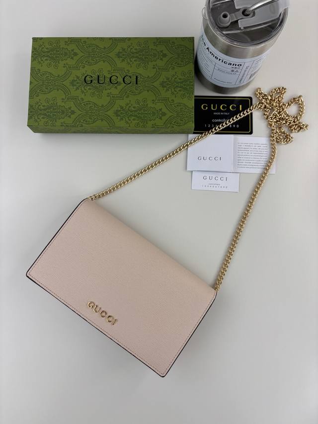 Guccl Chain wallet with script Gucci logo. The small leather accessories collect