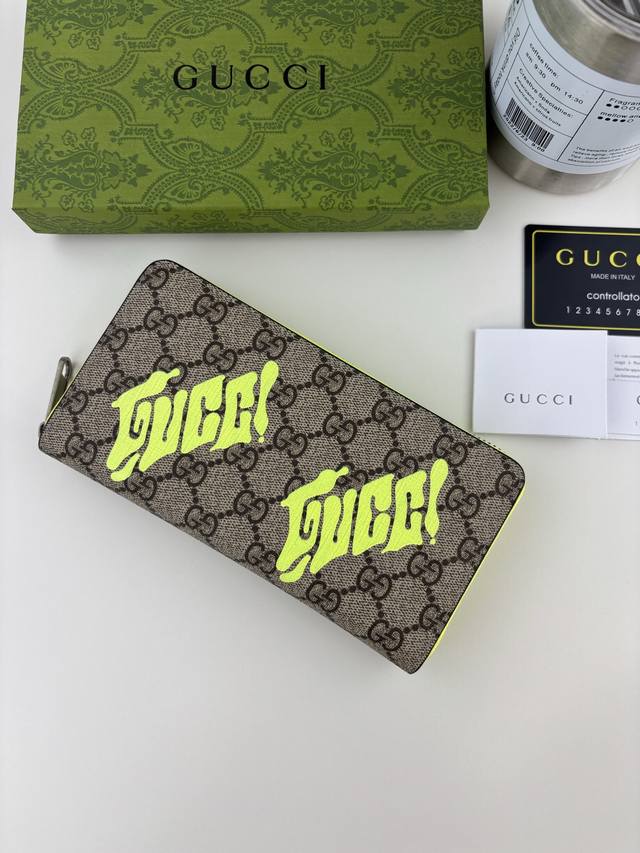 Guccl This zip-around wallet is crafted from coated fabric with the iconic Gg mo