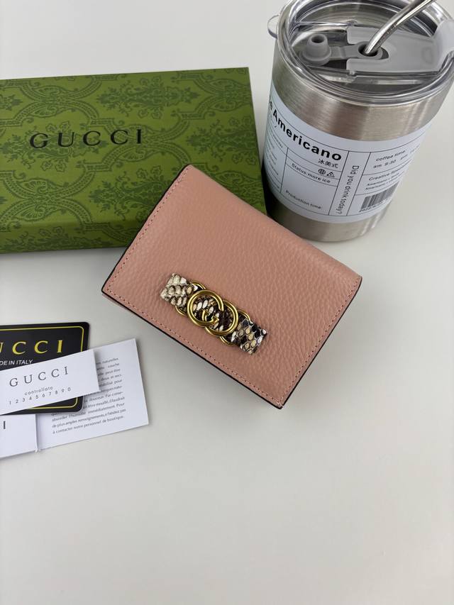Guccl's latest ~ small wallet with an interlocking double G python leather bow.