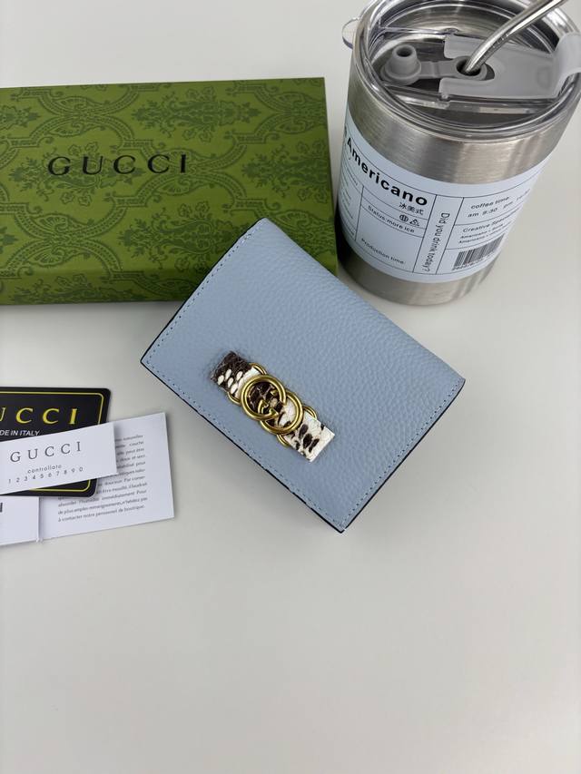 Guccl's latest ~ small wallet with an interlocking double G python leather bow.