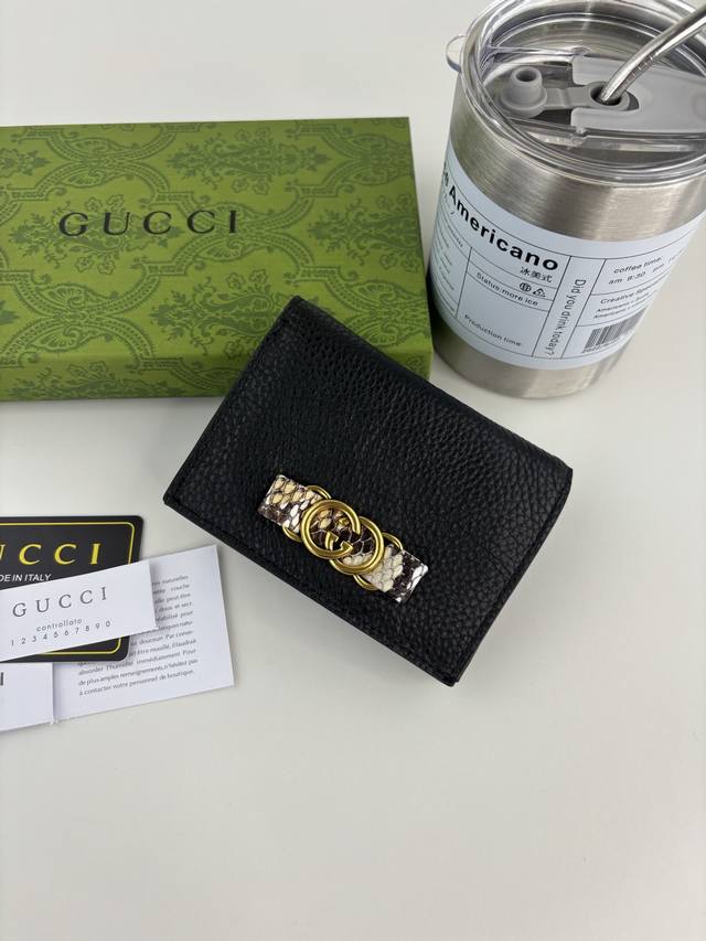 Guccl's latest ~ small wallet with an interlocking double G python leather bow.