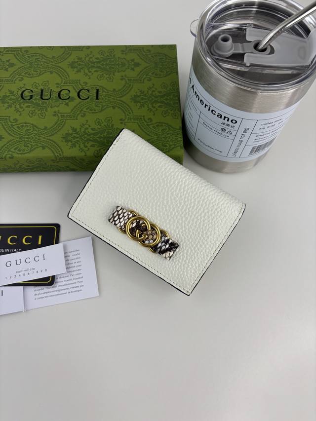 Guccl's latest ~ small wallet with an interlocking double G python leather bow.