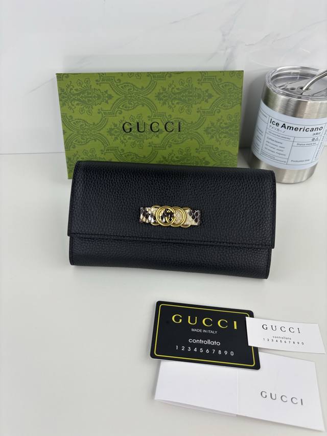 Guccl's latest wallet features an Interlocking G python bow. Crafted from genui