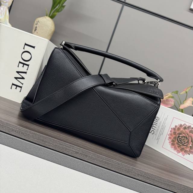 Low This new large, soft deerskin puzzle bag features a rectangular shape define