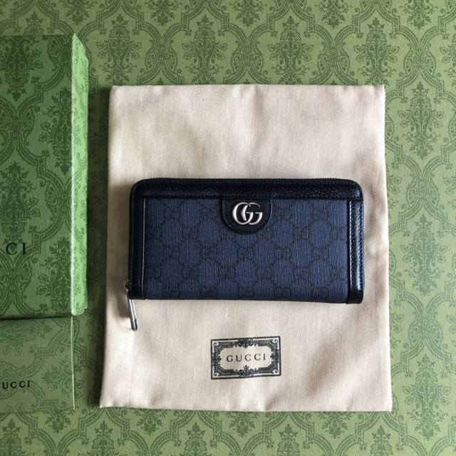 The premium G Ophida zip-around wallet, 706844, features blue and navy Supreme