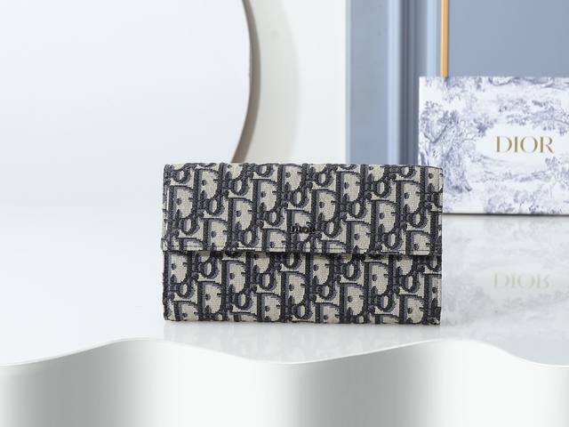 Style 312 Beige printed fabric, metal Dior logo on the front, flap and central