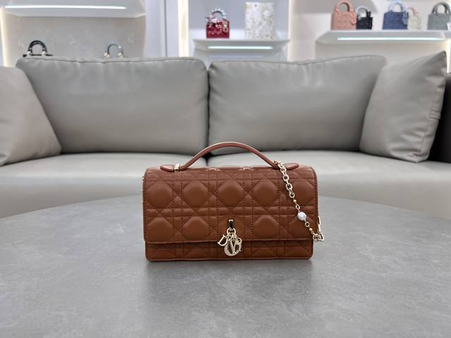 0980 Lambskin Bronze Lady Dior Pearl Clutch Bag. This new season clutch features