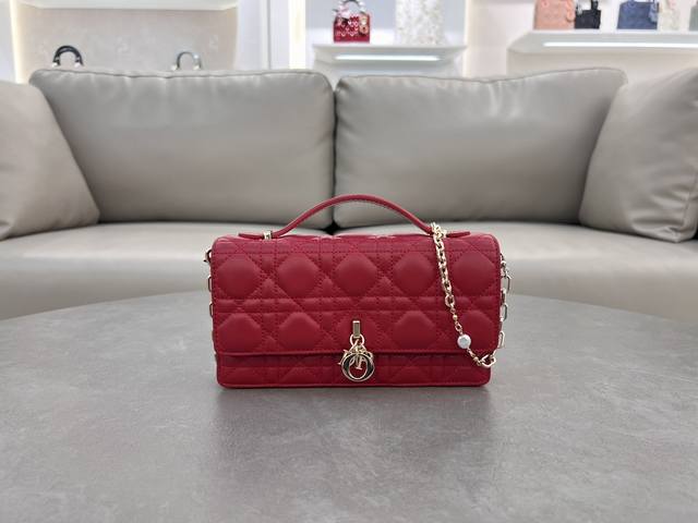 0980 Red Lambskin Lady Dior Pearl Clutch Bag. This new season clutch features a