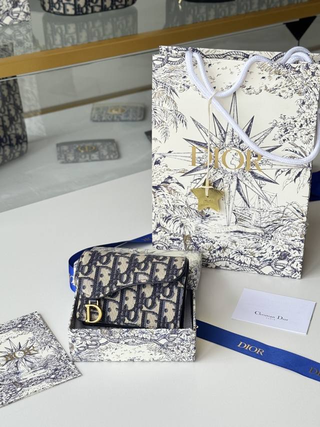 Dior's new saddle-shaped mini card holder made with Dior's exclusive fabric is n
